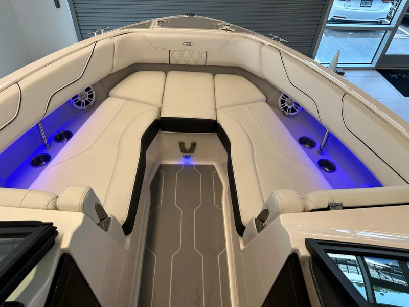Slide: The Image of Luxurious interior of 2025 Regal LX6 boat with ambient blue lighting and plush seating. - 9