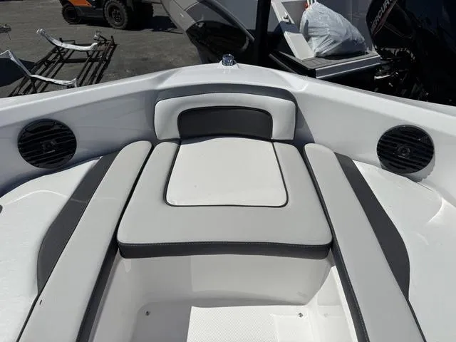 Slide: The Image of 2024 Yamaha Boats 195S interior seating with speakers and sleek design. - 11