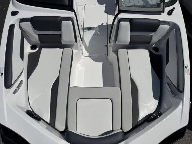 Slide: The Image of 2024 Yamaha Boats 195S interior, featuring sleek, modern seating in a spacious layout. - 13