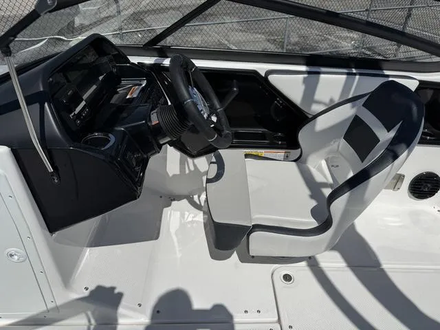 Slide: The Image of 2024 Yamaha Boats 195S cockpit with steering wheel and captain's chair. - 16