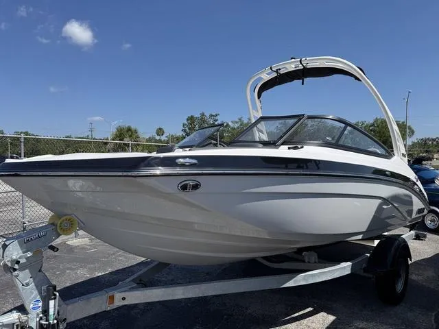 Slide: The Image of 2024 Yamaha Boats 195S on trailer, sleek design under clear blue sky. - 2