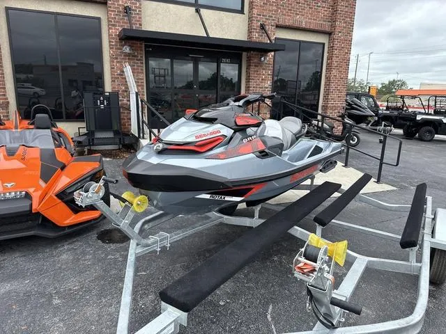 Slide: The Image of 2018 Sea-Doo Waverunner PW RXT-X 300 on trailer, parked outside a brick building. - 3