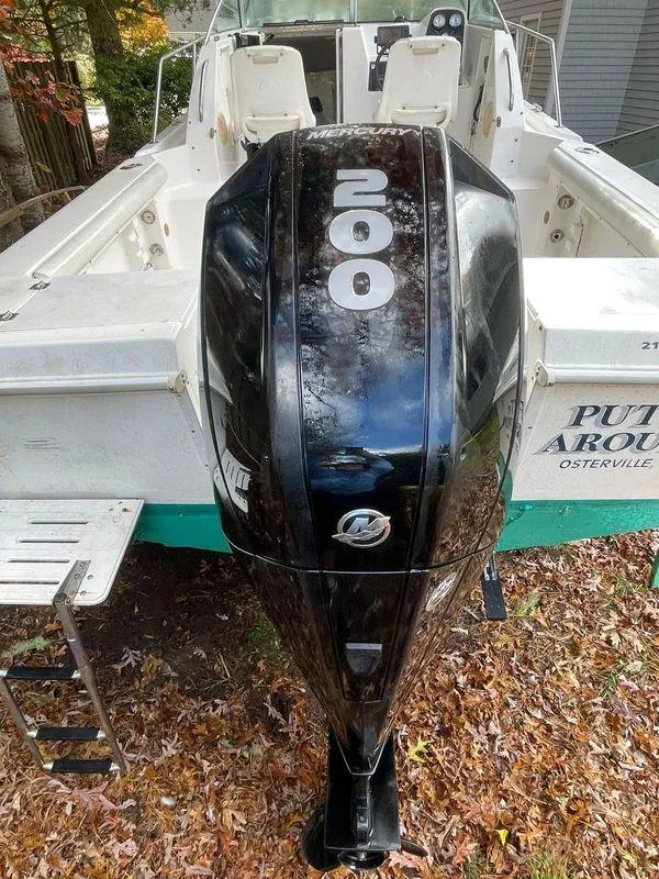Slide: The Image of 1998 Wellcraft 210 Coastal boat with powerful 200 HP outboard motor, parked on autumn leaves. - 6