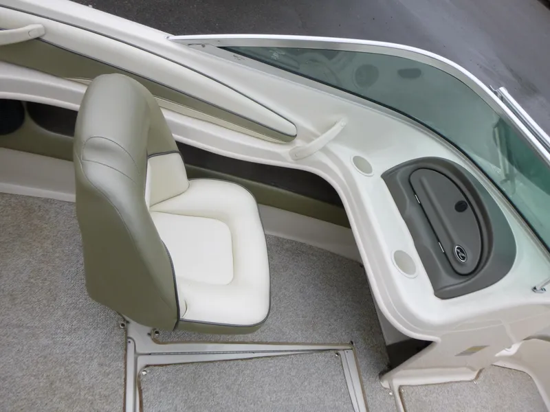Slide: The Image of 2005 Sea Ray 185 Sport boat interior with beige seating and dashboard. - 10