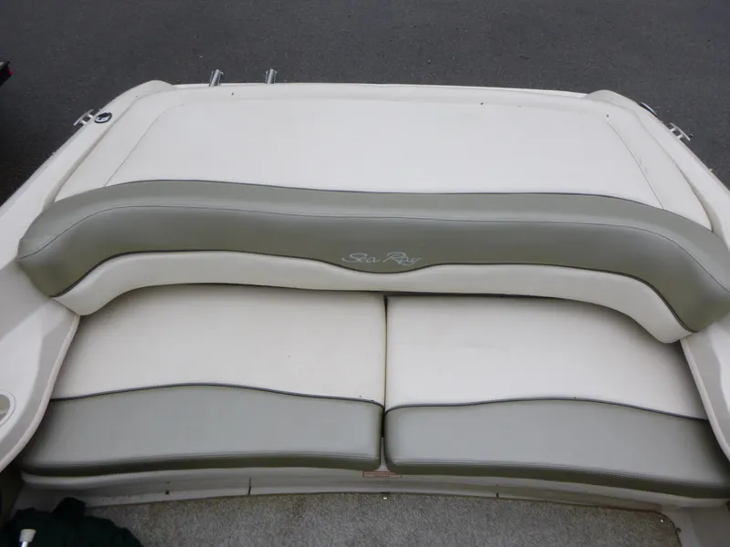Slide: The Image of Rear seating of a 2005 Sea Ray 185 Sport boat, featuring white and gray upholstery. - 11
