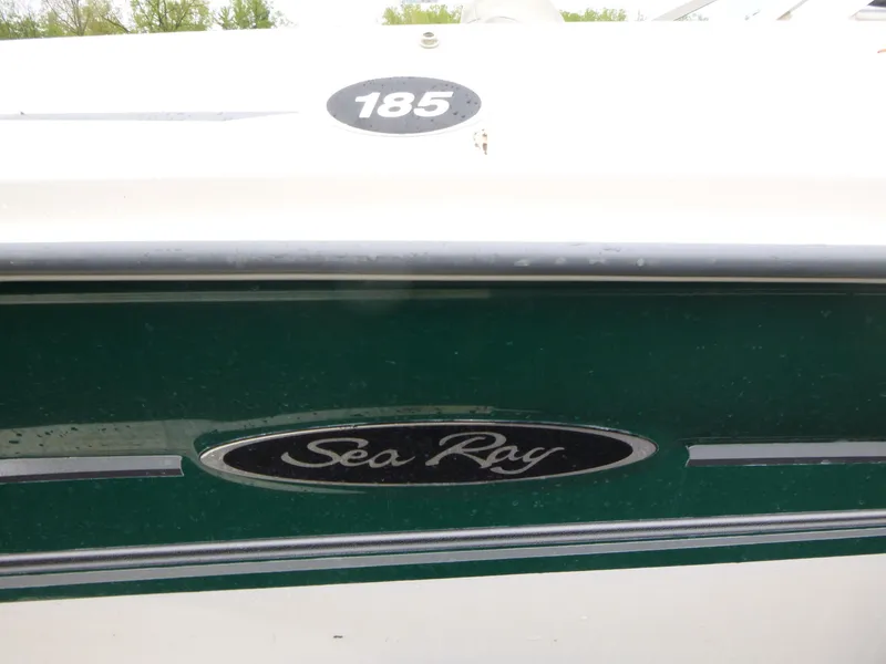 Slide: The Image of 2005 Sea Ray 185 Sport boat with green detailing and logo. - 13