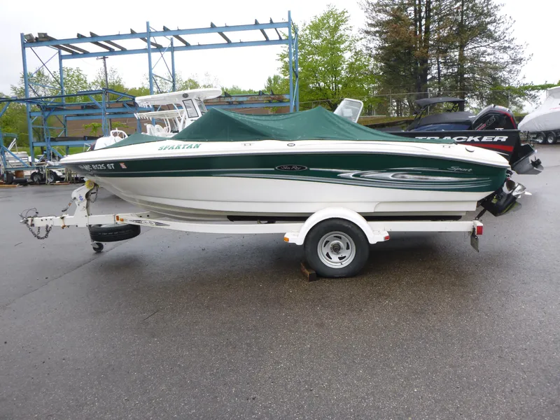 Slide: The Image of 2005 Sea Ray 185 Sport boat on trailer, covered, parked outdoors. - 4