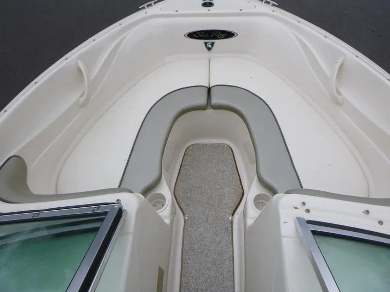 Slide: The Image of 2005 Sea Ray 185 Sport boat interior with cushioned seating and open bow design. - 6