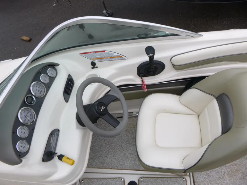 Slide: The Image of 2005 Sea Ray 185 Sport boat interior with steering wheel and dashboard controls. - 8