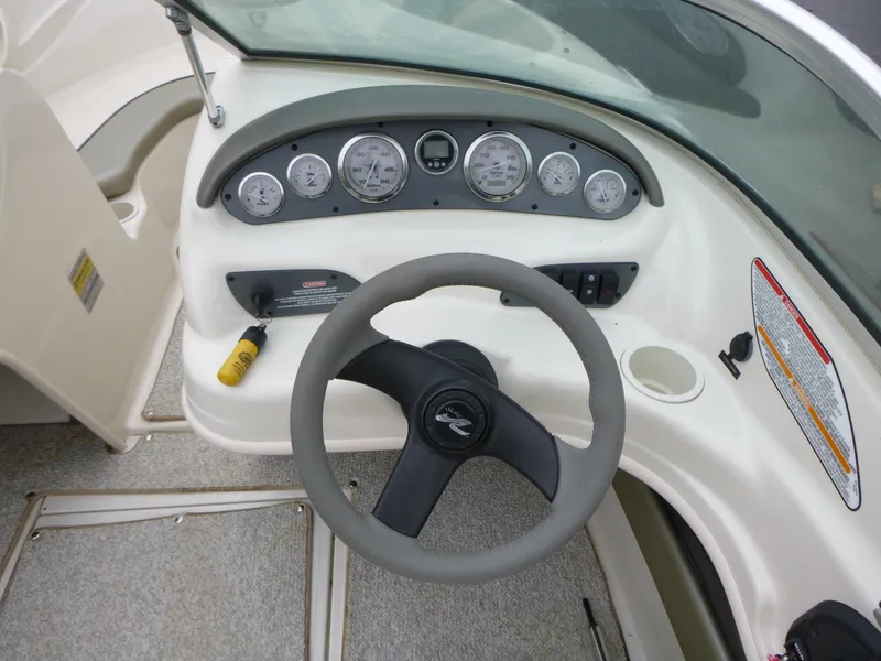 Slide: The Image of 2005 Sea Ray 185 Sport dashboard with steering wheel and instrument panel. - 9