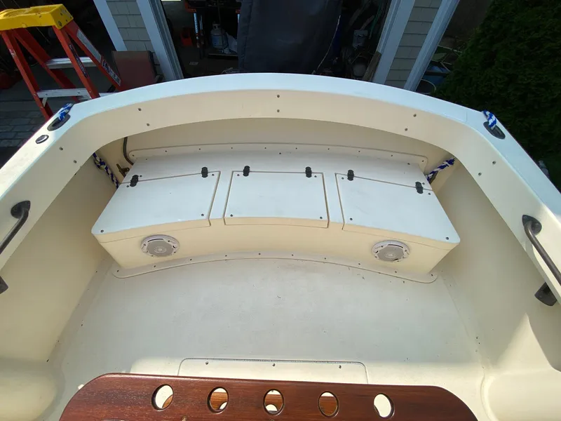 Slide: The Image of 2005 Roth Bilt 21 Classic boat interior with storage compartments and wooden accents. - 11