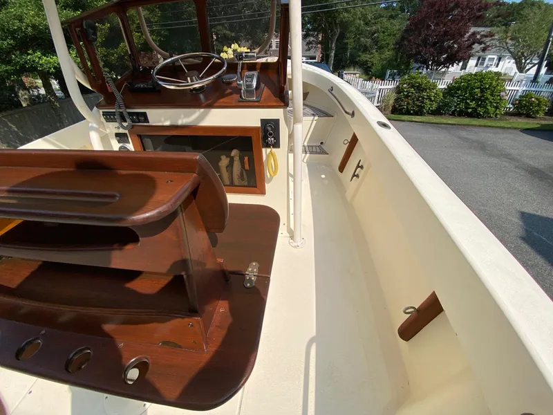 Slide: The Image of 2005 Roth Bilt 21 Classic boat interior with wooden helm and seating. - 12