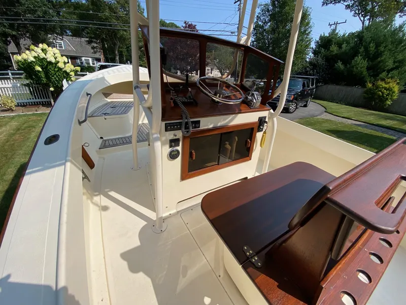 Slide: The Image of 2005 Roth Bilt 21 Classic boat interior with wooden console and seating. - 13