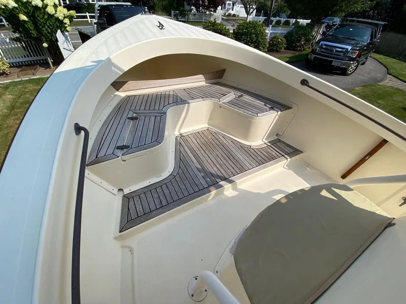 Slide: The Image of 2005 Roth Bilt 21 Classic boat interior with wooden deck and seating area. - 14
