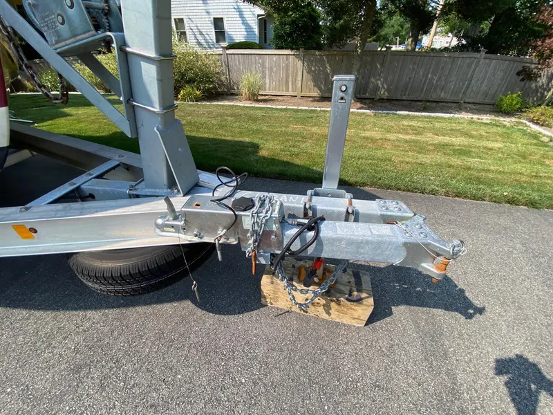 Slide: The Image of Trailer hitch of a 2005 Roth Bilt 21 Classic boat on a driveway. - 17