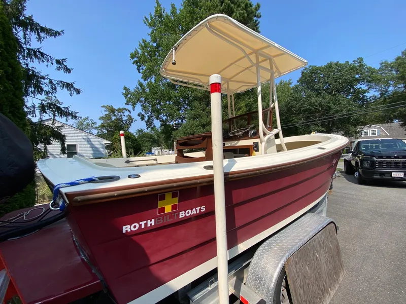 Slide: The Image of 2005 Roth Bilt 21 Classic boat on trailer, featuring a canopy and maroon hull. - 3