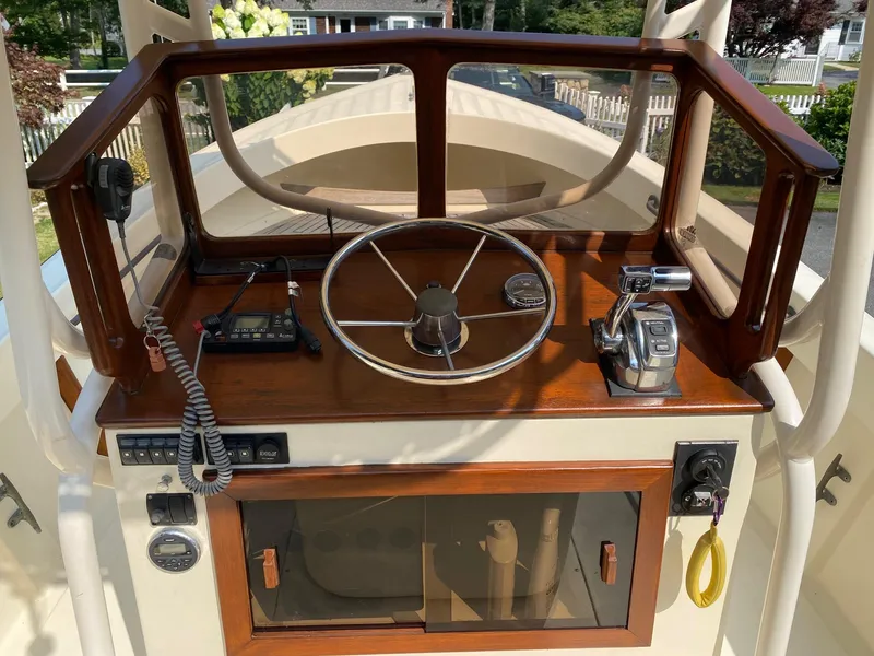Slide: The Image of 2005 Roth Bilt 21 Classic boat helm with wooden dashboard and steering wheel. - 6