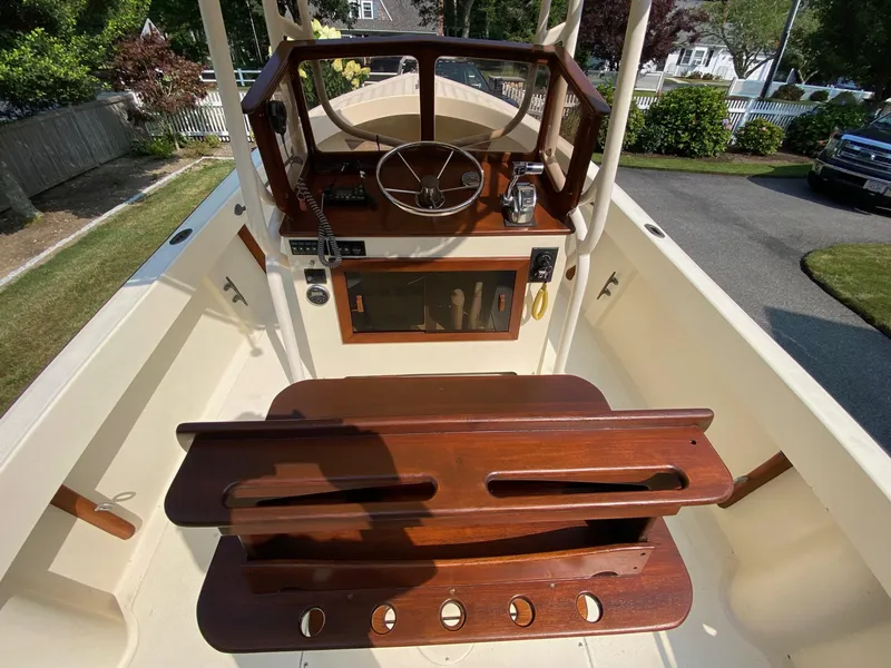 Slide: The Image of 2005 Roth Bilt 21 Classic boat interior with wooden helm and seating. - 7