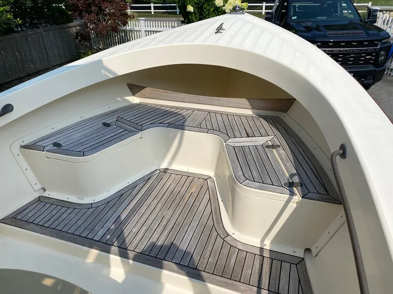 Slide: The Image of 2005 Roth Bilt 21 Classic boat with wooden deck and seating area. - 9