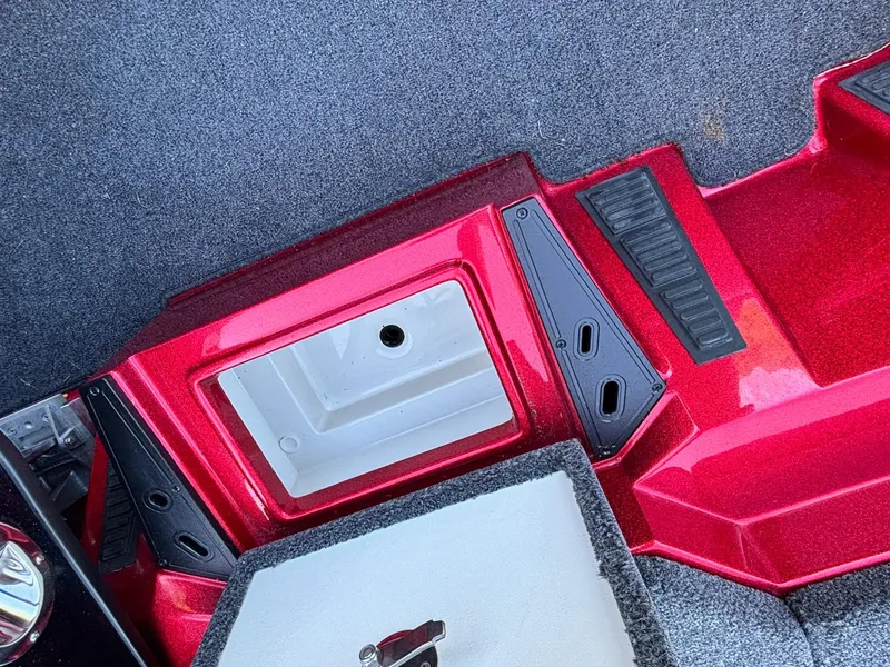 Slide: The Image of 2020 Ranger Z185 boat interior with red accents and storage compartment. - 8