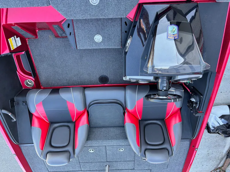 Slide: The Image of 2020 Ranger Z185 boat interior with red and gray seats, steering console, and carpeted flooring. - 9