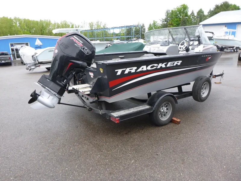 Slide: The Image of 2011 Tracker Targa V-18 WT boat on trailer with outboard motor in parking lot. - 4