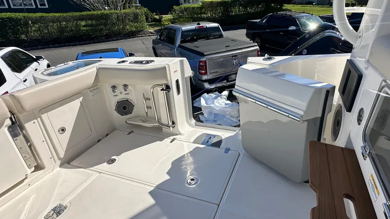 Slide: The Image of 2025 Boston Whaler 405 Conquest boat interior with seating and storage compartments. - 12