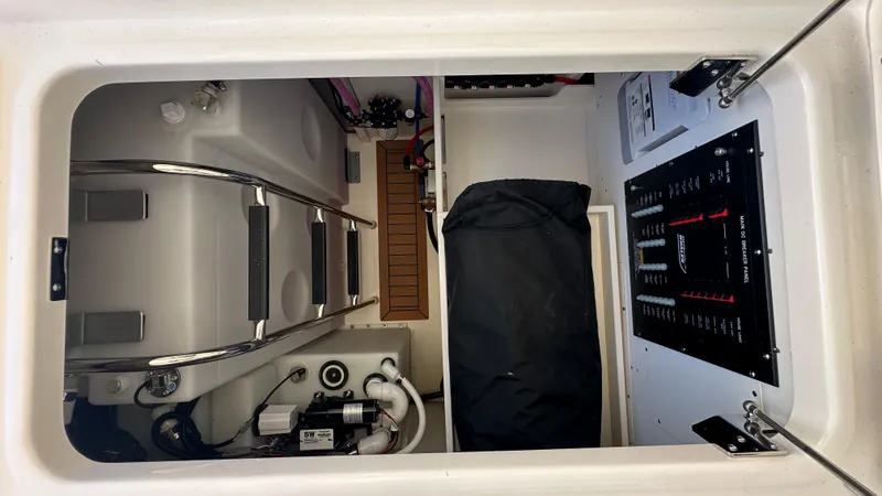 Slide: The Image of 2025 Boston Whaler 405 Conquest interior compartment with control panel and storage. - 14