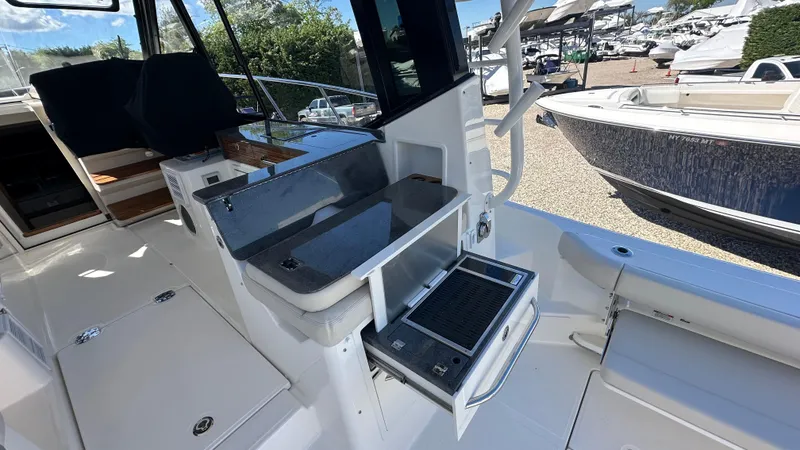 Slide: The Image of 2025 Boston Whaler 405 Conquest boat interior with seating and storage compartments. - 18