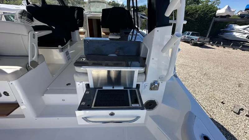 Slide: The Image of 2025 Boston Whaler 405 Conquest boat interior with seating and storage compartments. - 19