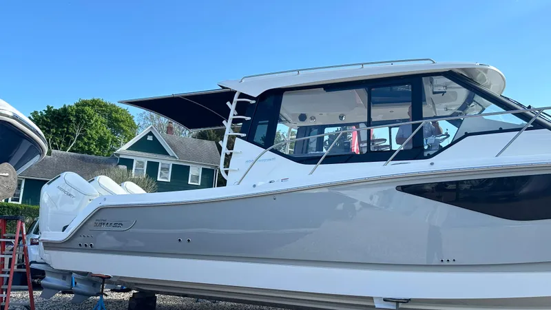 Slide: The Image of 2025 Boston Whaler 405 Conquest boat docked, showcasing sleek design and modern features. - 2