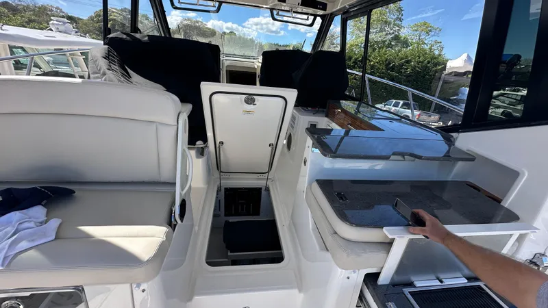 Slide: The Image of 2025 Boston Whaler 405 Conquest interior with seating and control area. - 23