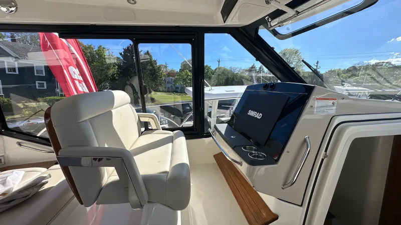 Slide: The Image of Interior of 2025 Boston Whaler 405 Conquest boat, featuring helm and seating area. - 29