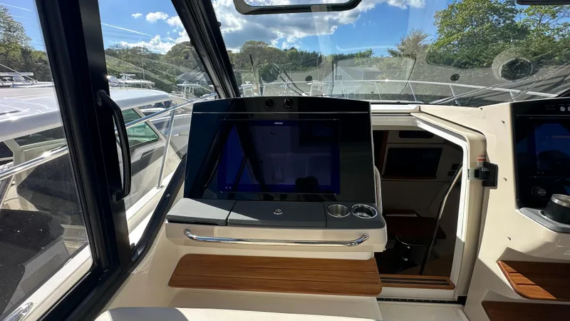 Slide: The Image of Interior view of 2025 Boston Whaler 405 Conquest boat cockpit with navigation display. - 30