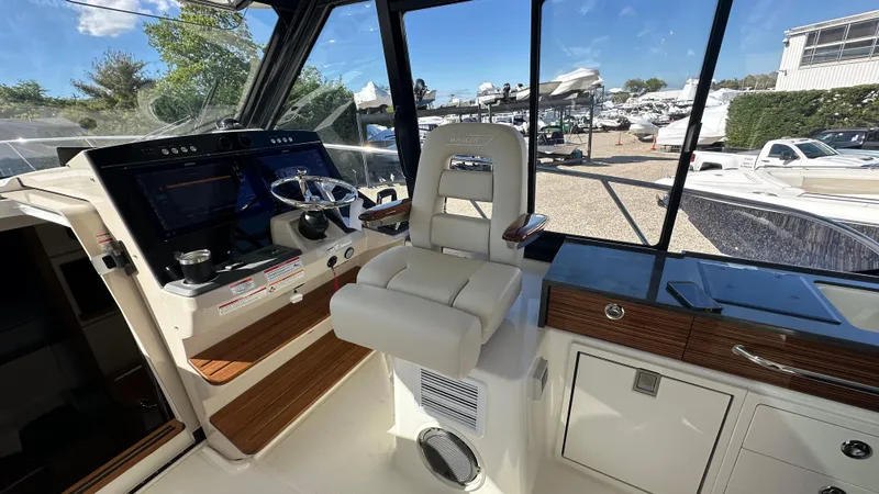 Slide: The Image of 2025 Boston Whaler 405 Conquest helm with modern controls and comfortable seating. - 34