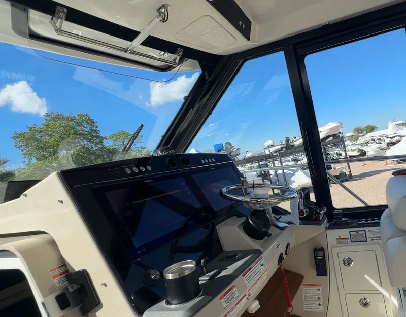 Slide: The Image of Interior view of 2025 Boston Whaler 405 Conquest helm with modern navigation equipment. - 35