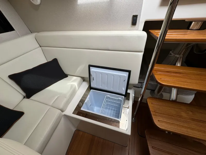Slide: The Image of Interior of 2025 Boston Whaler 405 Conquest with built-in cooler and wooden stairs. - 40