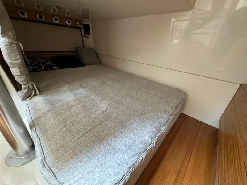 Slide: The Image of 2025 Boston Whaler 405 Conquest cabin interior with comfortable bed and modern design. - 42