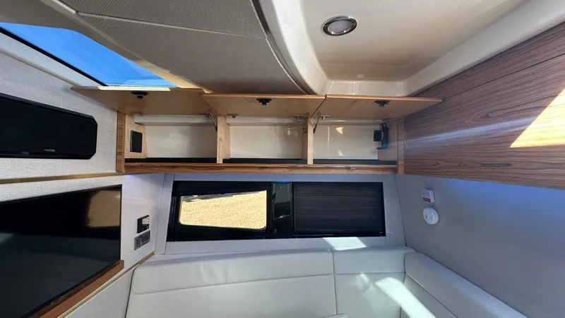 Slide: The Image of Interior of 2025 Boston Whaler 405 Conquest, featuring open storage and modern seating. - 49