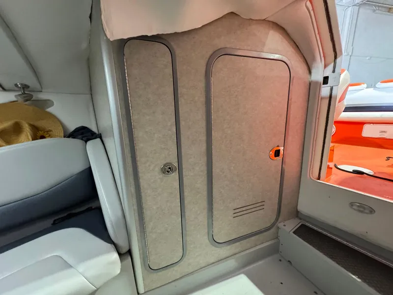 Slide: The Image of Interior cabin of a 2007 Baja 35 Outlaw boat, featuring seating and storage compartments. - 19