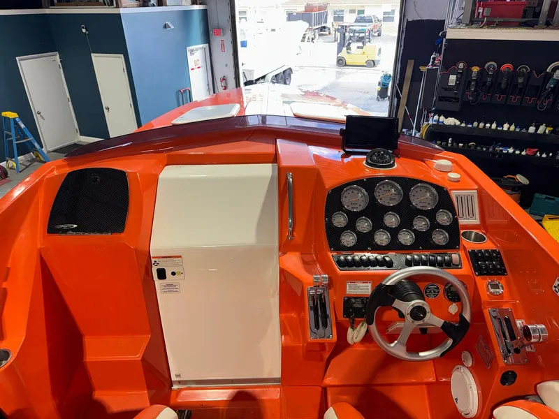 Slide: The Image of 2007 Baja 35 Outlaw boat cockpit with vibrant orange dashboard and steering wheel. - 29