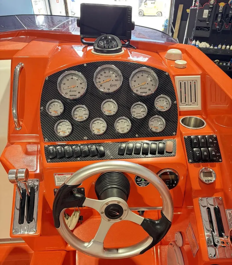 Slide: The Image of 2007 Baja 35 Outlaw dashboard with gauges and controls, featuring an orange and black design. - 30