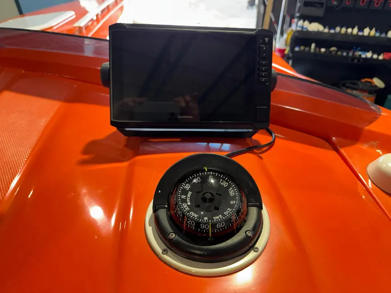 Slide: The Image of 2007 Baja 35 Outlaw boat dashboard with compass and Garmin device. - 5