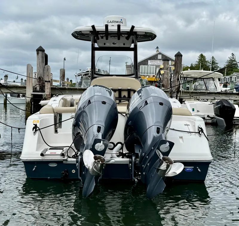 Slide: The Image of 2020 Tidewater 252 LXF boat with dual engines docked at marina. - 5