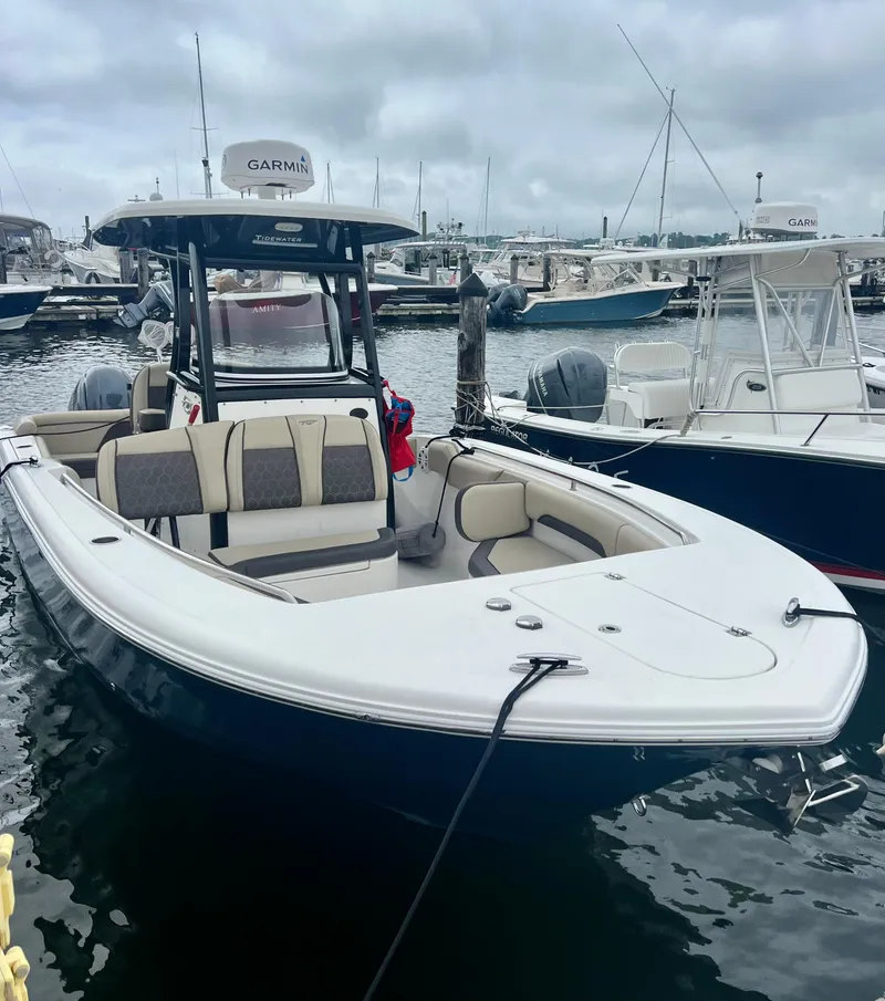 Slide: The Image of 2020 Tidewater 252 LXF boat docked in marina, overcast sky, Garmin radar visible. - 8