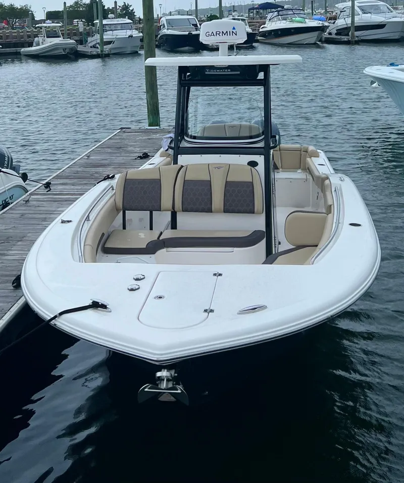 Slide: The Image of 2020 Tidewater 252 LXF boat docked at marina, featuring spacious seating and Garmin equipment. - 9