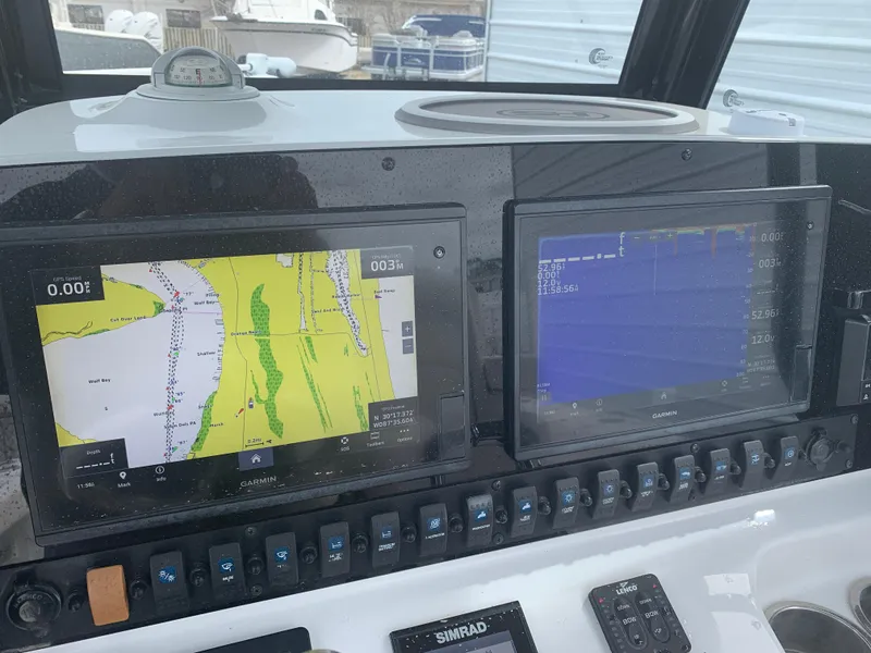 Slide: The Image of Dashboard of 2020 Sea Hunt Gamefish 27 with navigation screens and controls. - 15