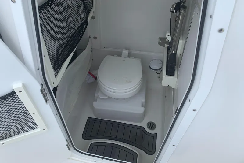 Slide: The Image of 2020 Sea Hunt Gamefish 27 boat interior with compact marine toilet. - 24