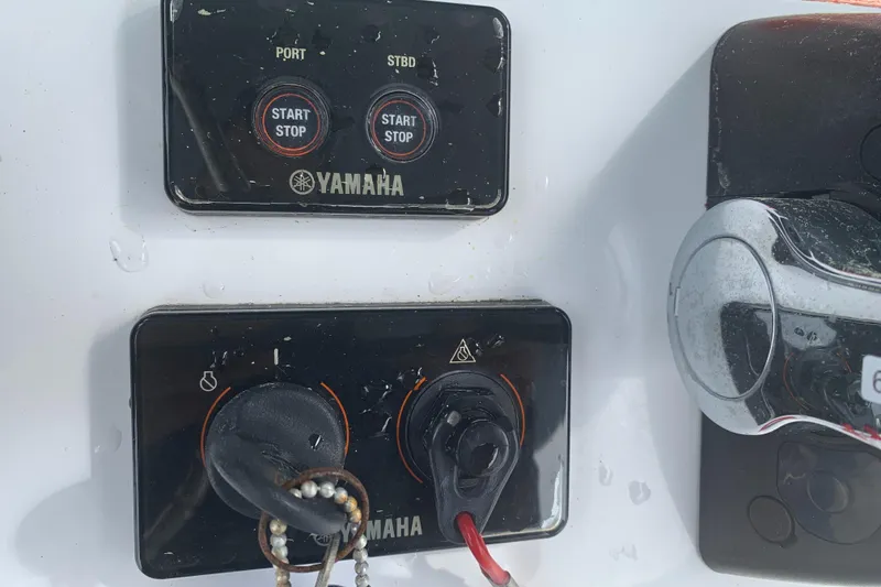Slide: The Image of Control panel of a 2020 Sea Hunt Gamefish 27 boat with Yamaha start-stop buttons. - 28