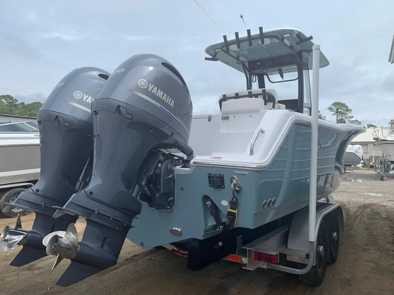 Slide: The Image of 2020 Sea Hunt Gamefish 27 boat with dual Yamaha engines on a trailer. - 3
